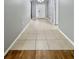 Inviting entryway with neutral tile flooring leading to a bright, white front door and complementing gray walls at 1940 Banner Ln, St Cloud, FL 34769