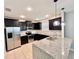 Stylish kitchen with granite countertops, stainless steel appliances, dark cabinets, and recessed lighting at 1940 Banner Ln, St Cloud, FL 34769