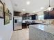 Modern kitchen with stainless steel appliances and granite countertops at 1940 Banner Ln, Saint Cloud, FL 34769