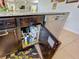 Kitchen cabinet with water filtration system and various supplies at 1940 Banner Ln, St Cloud, FL 34769