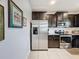 Stainless steel appliances and dark wood cabinets in this kitchen at 1940 Banner Ln, St Cloud, FL 34769