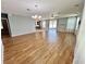 Open concept living room with stylish hardwood flooring, modern lighting fixtures, and sliding glass doors to the outdoor area at 1940 Banner Ln, St Cloud, FL 34769