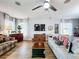Bright living room featuring hardwood floors, comfy sofas, and a large TV at 1940 Banner Ln, St Cloud, FL 34769