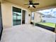 View of a screened patio with a ceiling fan overlooking the backyard at 1940 Banner Ln, St Cloud, FL 34769