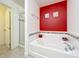 Clean and modern bathroom featuring a soaking tub, separate shower, and sleek tile work at 4191 Oaktree Drive, Davenport, FL 33837