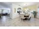 Elegant dining area with a chandelier, stylish decor, and tile flooring at 4191 Oaktree Drive, Davenport, FL 33837