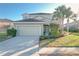 Charming two-story home with a well-manicured lawn, tile roof, and inviting curb appeal at 4191 Oaktree Drive, Davenport, FL 33837
