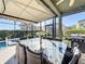 Relaxing screened patio featuring a glass table, eight cushioned seats, and an outdoor grill at 4191 Oaktree Drive, Davenport, FL 33837