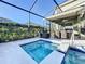 Inviting screened-in pool with spa and covered outdoor dining area for relaxation and entertaining at 4191 Oaktree Drive, Davenport, FL 33837