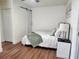 Bedroom with wood-look floors, barn door, closet, and calming decor at 4950 Nova Ave, St Cloud, FL 34773