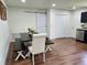 Dining room area with wood-look floors, barn door, table with chairs and bench with white trim throughout at 4950 Nova Ave, St Cloud, FL 34773