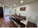 Dining room with a wooden table, chairs and bench seating, and view to kitchen at 4950 Nova Ave, St Cloud, FL 34773