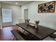 Bright dining room features a dark wood table, bench seating and modern decor with white trim throughout at 4950 Nova Ave, St Cloud, FL 34773