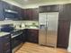 Bright kitchen features stainless steel appliances, granite countertops, and dark wood cabinets at 4950 Nova Ave, St Cloud, FL 34773