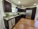 Angle of modern kitchen featuring stainless steel appliances, granite countertops, and dark wood cabinets at 4950 Nova Ave, St Cloud, FL 34773