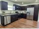 View of the kitchen featuring stainless steel appliances, granite countertops, and dark wood cabinets at 4950 Nova Ave, St Cloud, FL 34773