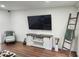 Inviting living room featuring a TV, stylish ladder and rustic decor at 4950 Nova Ave, St Cloud, FL 34773