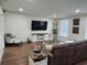 Bright living room featuring a sofa, TV, and stylish modern decor at 4950 Nova Ave, St Cloud, FL 34773