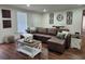 Living room with brown leather sofa, stylish decor and hardwood floors at 4950 Nova Ave, St Cloud, FL 34773