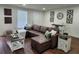 Living room with brown leather sofa, stylish decor, and ample lighting at 4950 Nova Ave, St Cloud, FL 34773