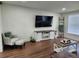 Bright living room with stylish chair and ottoman, TV and rustic decor at 4950 Nova Ave, St Cloud, FL 34773