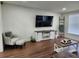 Inviting living room with TV, chair and ottoman, and rustic decor at 4950 Nova Ave, St Cloud, FL 34773