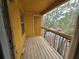 View of a balcony with a railing overlooking a green space with trees at 5267 Images Cir # 303, Kissimmee, FL 34746