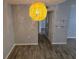 View of a dining area showcasing wood-look flooring, gray walls and a modern hanging light fixture at 5267 Images Cir # 303, Kissimmee, FL 34746