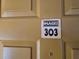 Close up of unit 303 front door with the unit number and an Images logo sign at 5267 Images Cir # 303, Kissimmee, FL 34746