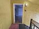 View through doorway into a living room with gray walls and wood-look flooring at 5267 Images Cir # 303, Kissimmee, FL 34746