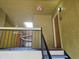 Hallway showing stairway, doorways and an overhead exit sign and skylight at 5267 Images Cir # 303, Kissimmee, FL 34746