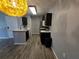 Kitchen with stainless steel appliances, dark cabinetry, and wood-look flooring at 5267 Images Cir # 303, Kissimmee, FL 34746