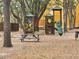 Exterior view of the community playground and picnic area under mature shade trees at 5267 Images Cir # 303, Kissimmee, FL 34746