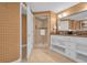 Elegant bathroom with double vanity, walk-in shower, and large mirror at 7593 Gathering Dr # 608, Reunion, FL 34747