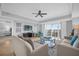 Bright living room featuring comfortable sofas and a large TV at 7593 Gathering Dr # 608, Reunion, FL 34747