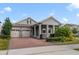 Two-story house with a gray exterior, brick driveway, and landscaping at 9553 Nautique Ln, Winter Garden, FL 34787