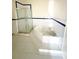 Bright bathroom showcasing a garden tub and a glass-enclosed shower with blue tile accents at 1069 Universal Rest Pl, Kissimmee, FL 34744