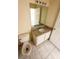 Bathroom with neutral countertops, tile floor, large mirror, and updated fixtures at 1069 Universal Rest Pl, Kissimmee, FL 34744