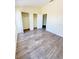 Bedroom with hardwood floors, two closets, and two entries at 1069 Universal Rest Pl, Kissimmee, FL 34744
