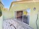 Outdoor deck with paint damage featuring sliding glass door into room with hardwood floors at 1069 Universal Rest Pl, Kissimmee, FL 34744