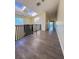 Bright upstairs hallway with hardwood floors, and a stairway with a black metal railing at 1069 Universal Rest Pl, Kissimmee, FL 34744