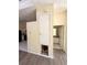 Hallway showing access to kitchen and bathroom; neutral wall colors; gray wood floors at 1069 Universal Rest Pl, Kissimmee, FL 34744
