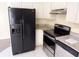 Kitchen with a stainless steel dishwasher, black refrigerator, and granite countertops at 1069 Universal Rest Pl, Kissimmee, FL 34744