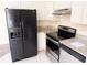 Kitchen with a stainless steel dishwasher, black refrigerator, and granite countertops at 1069 Universal Rest Pl, Kissimmee, FL 34744