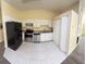 A bright, compact kitchen featuring stainless steel appliances and white cabinetry at 1069 Universal Rest Pl, Kissimmee, FL 34744