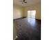 Spacious living room with sliding glass doors and wood-look laminate flooring at 1069 Universal Rest Pl, Kissimmee, FL 34744