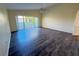 Living room featuring hardwood floors, a ceiling fan, and sliding glass doors at 1069 Universal Rest Pl, Kissimmee, FL 34744