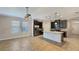 Well-lit kitchen features stainless steel appliances, granite countertops and a white kitchen island at 16059 Hampton Crossing Dr, Winter Garden, FL 34787