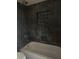 Bathroom with gray tiled walls and a shower head at 1700 Kentucky Ave, St Cloud, FL 34769