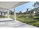 Covered back patio overlooks a grassy backyard with mature trees at 1740 Carnelian St, Deland, FL 32720